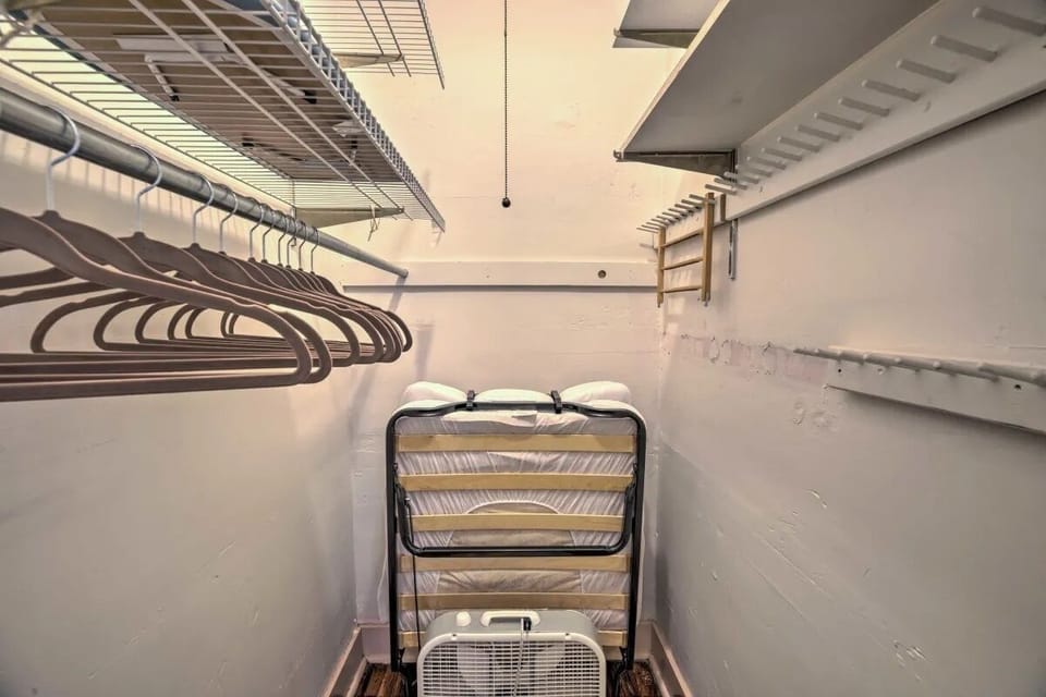 Primary Walk-in Closet stores the comfortable memory foam, twin roll-away bed.