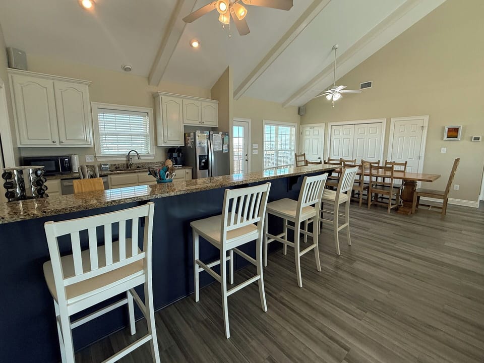 Your spacious kitchen features granite counters, modern appliances, and bar seating where you can enjoy morning coffee while planning adventures.