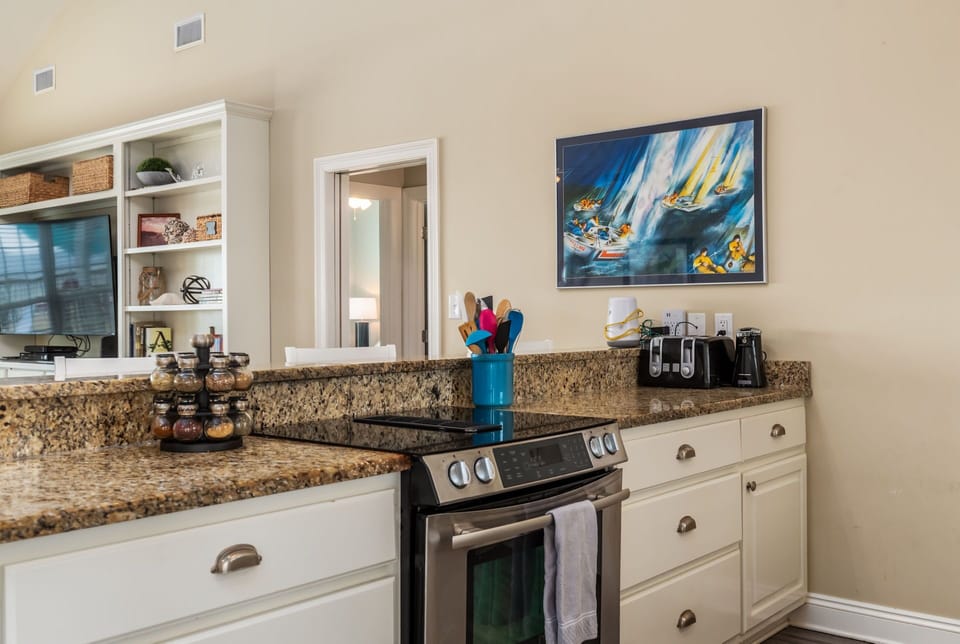 Your spacious kitchen features granite countertops, stainless appliances, and thoughtful touches that make cooking feel like home.