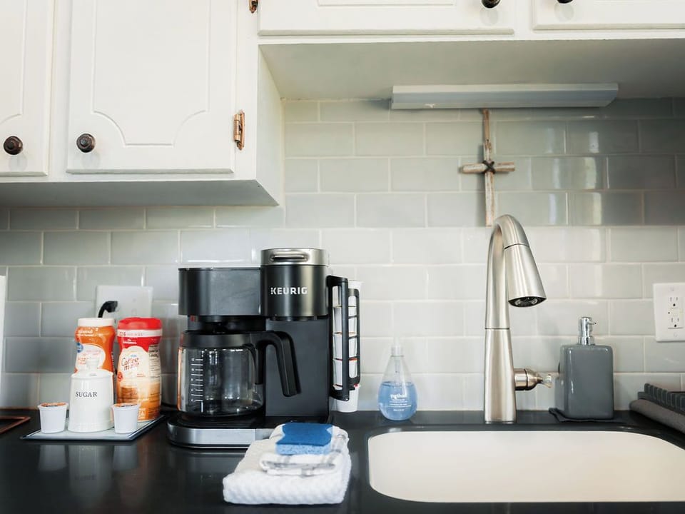 Fully stocked kitchen with drip or keurig coffee maker.