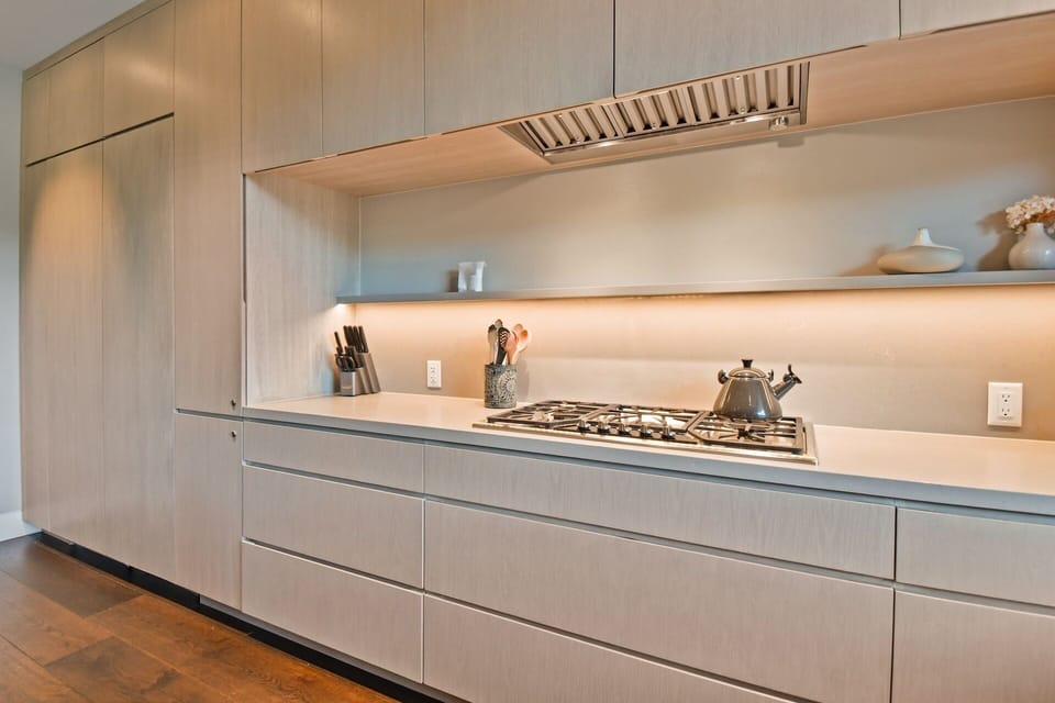 A sleek, modern kitchen with warm ambient lighting awaits your culinary adventures. Enjoy cooking with professional appliances in this beautifully designed space.