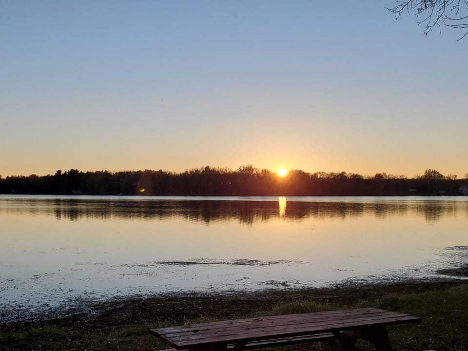 Photo of sunset from the front steps of the cabin.