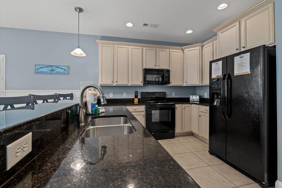 Your fully equipped kitchen offers granite countertops and modern appliances for preparing memorable meals together.