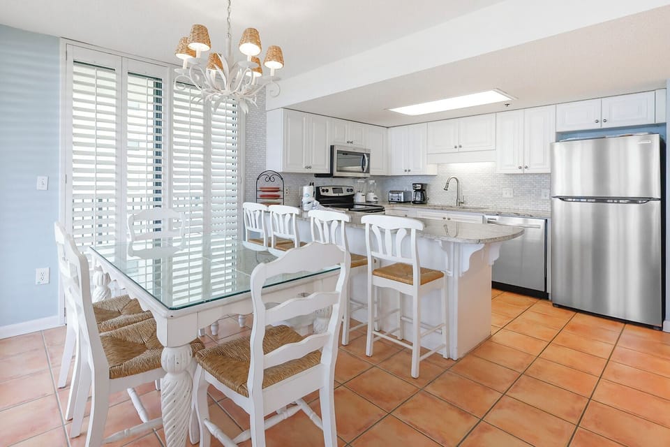 Enjoy meals in this inviting kitchen space, featuring stainless appliances and elegant design
