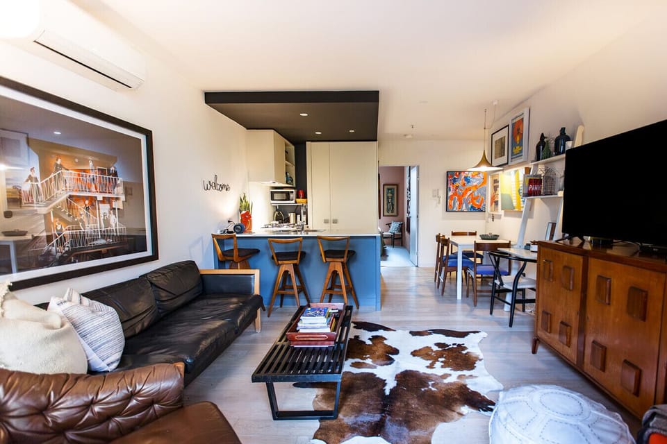 Modern open-plan layout with kitchen, dining, and extra bench seating for added comfort.