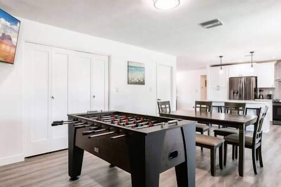 Dining room table sits six. Competition size Foosball table, laundry closet and 55 in smart TV. Open