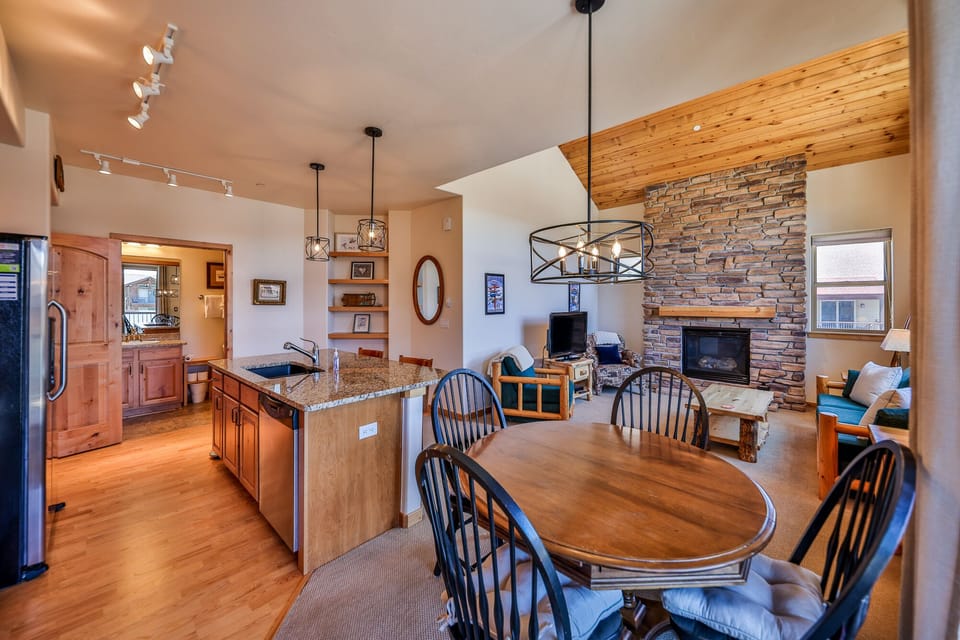 large kitchen connected to living room with seating for 6