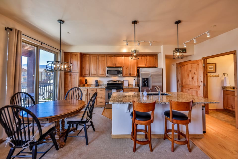 Dining table and counter stools provide seating for 6