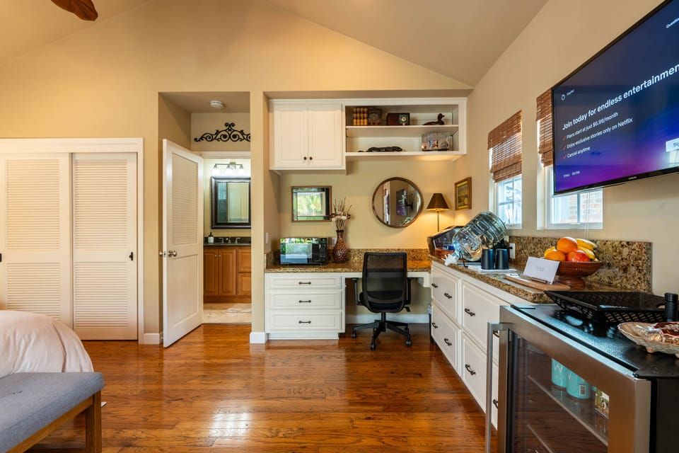 Closet to left with ironing board,m. Stocked fridge, office space to right. 
