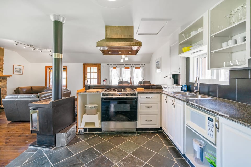 Kitchen, natural gas fireplace on left. New electric range now installed.