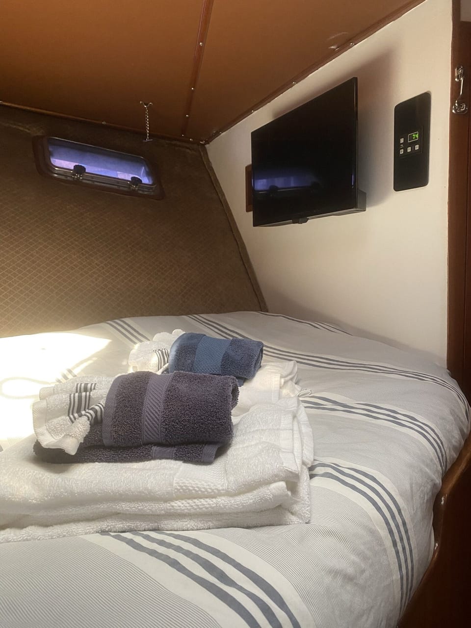 The wall-mounted tv in the v-berth cabin