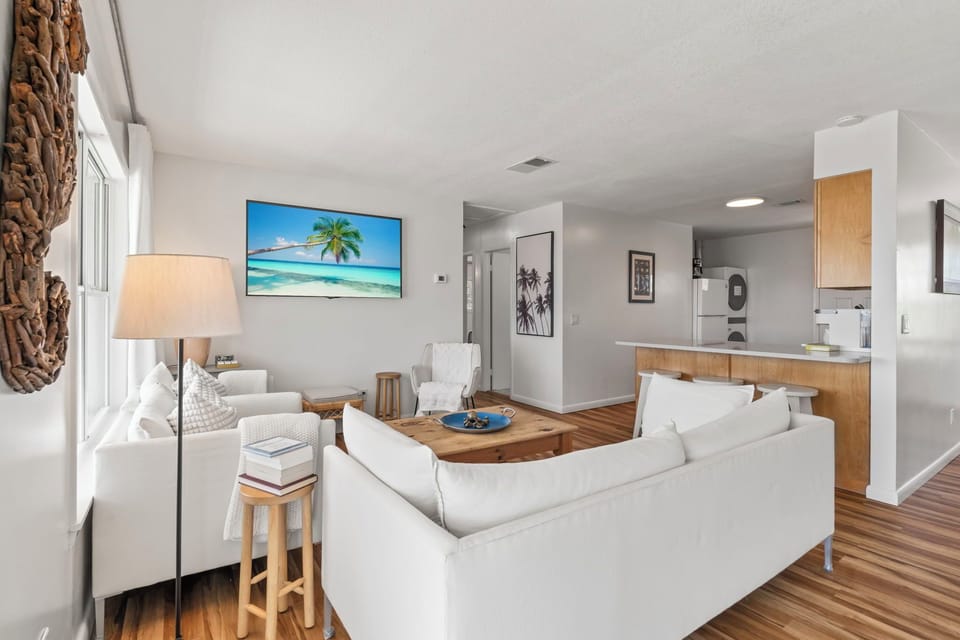 With a coastal-modern touch, this living and kitchen space is made for unwinding. Gather here for coffee, conversation, or movie nights — all with ocean views peeking through the windows and doors.
