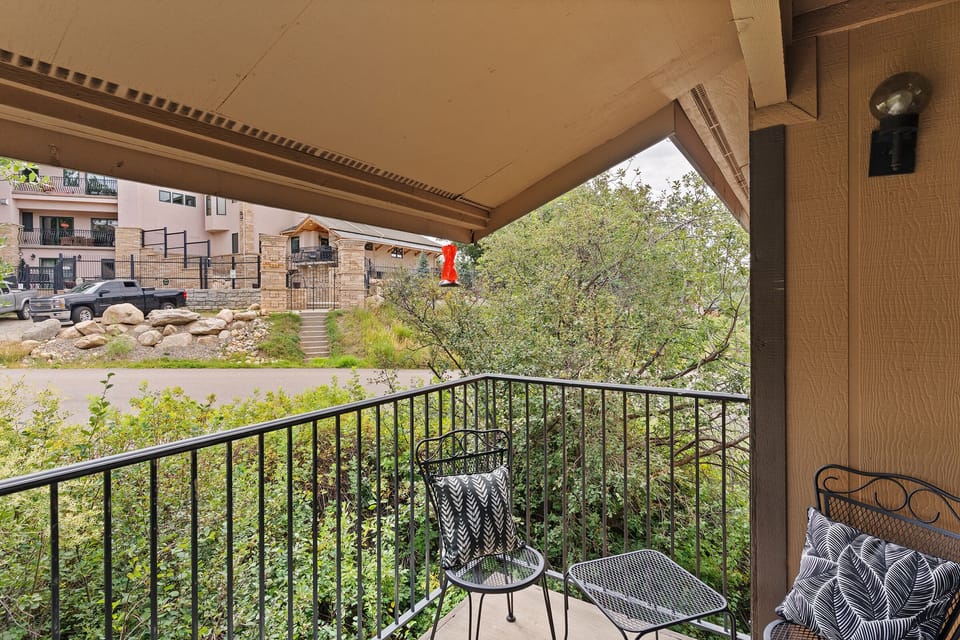 Balcony with seating for four and a grill