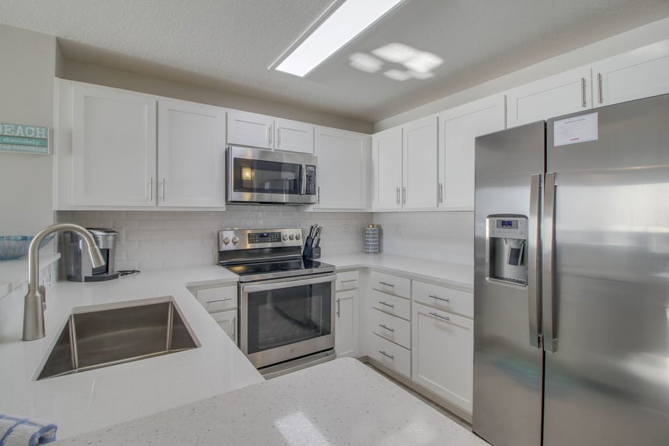 Beautiful kitchen with stainless steel appliances and large sink.