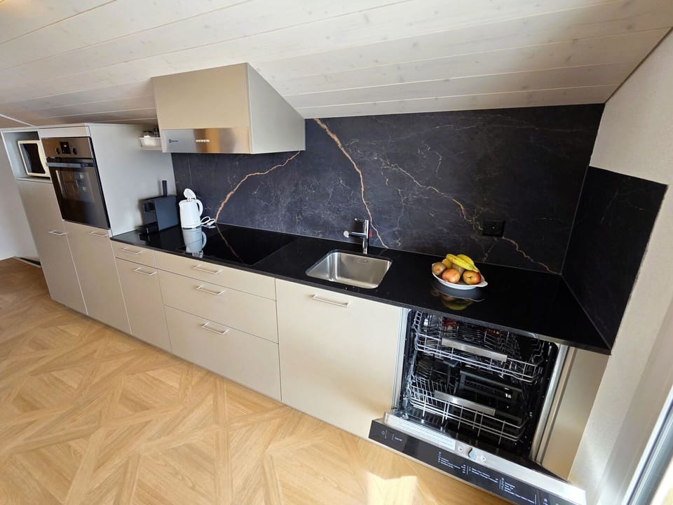 Flooring, Kitchen, Floor, Countertop, Kitchen Appliance, Major Appliance, Wood Flooring, Cabinetry, Natural Material, Tile