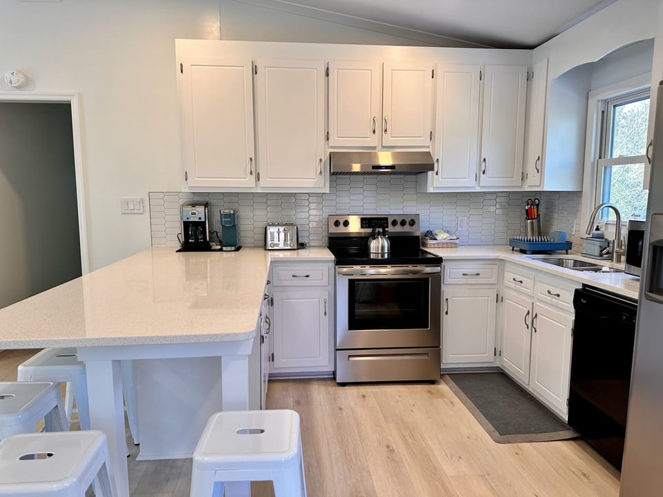 Fully equipped kitchen with large eat-in island that sits 7