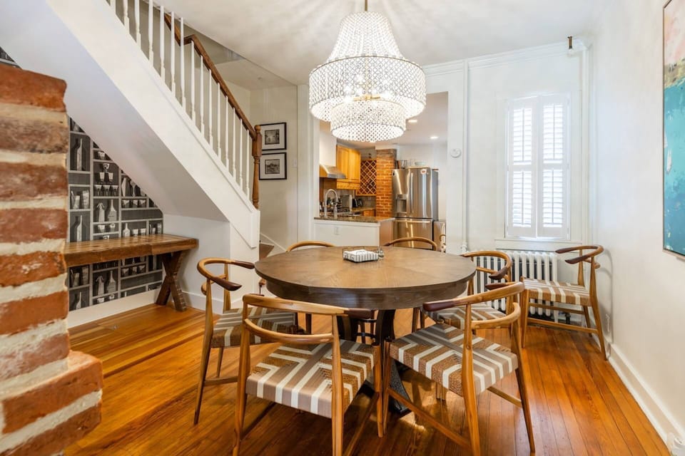 The dining room table has seating for 6 and is located on the other side of the 2-sided gas fireplace.