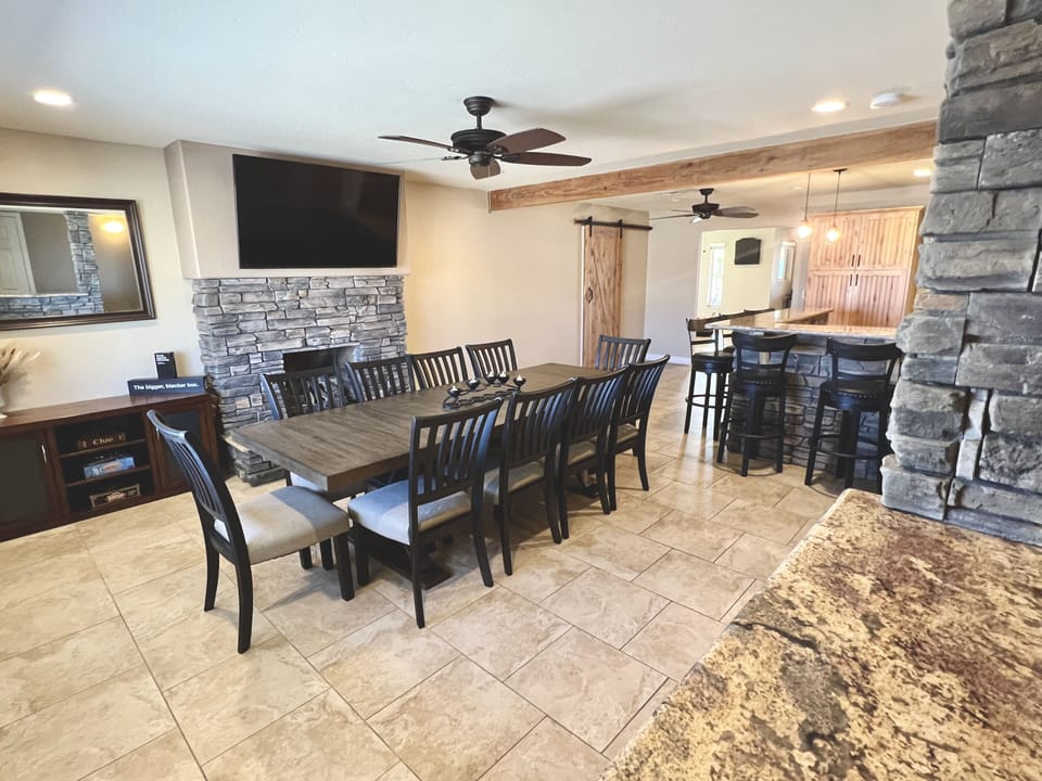 Dining area that seats 16 between table and granite/stone bar. Roku enabled TV