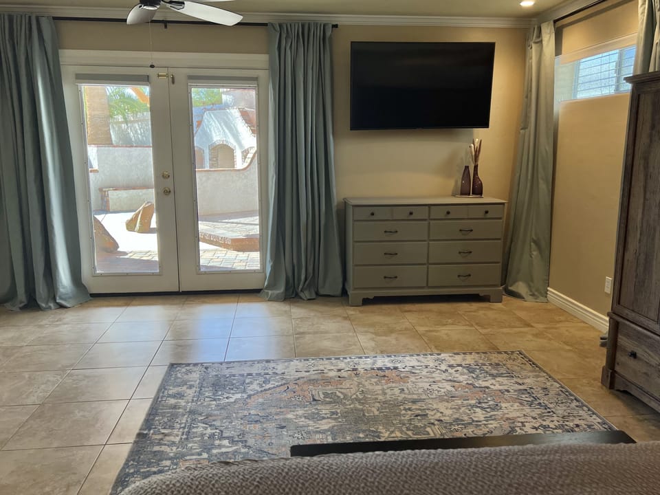 French doors that lead to the backyard and Roku enabled TV in Master Bedroom