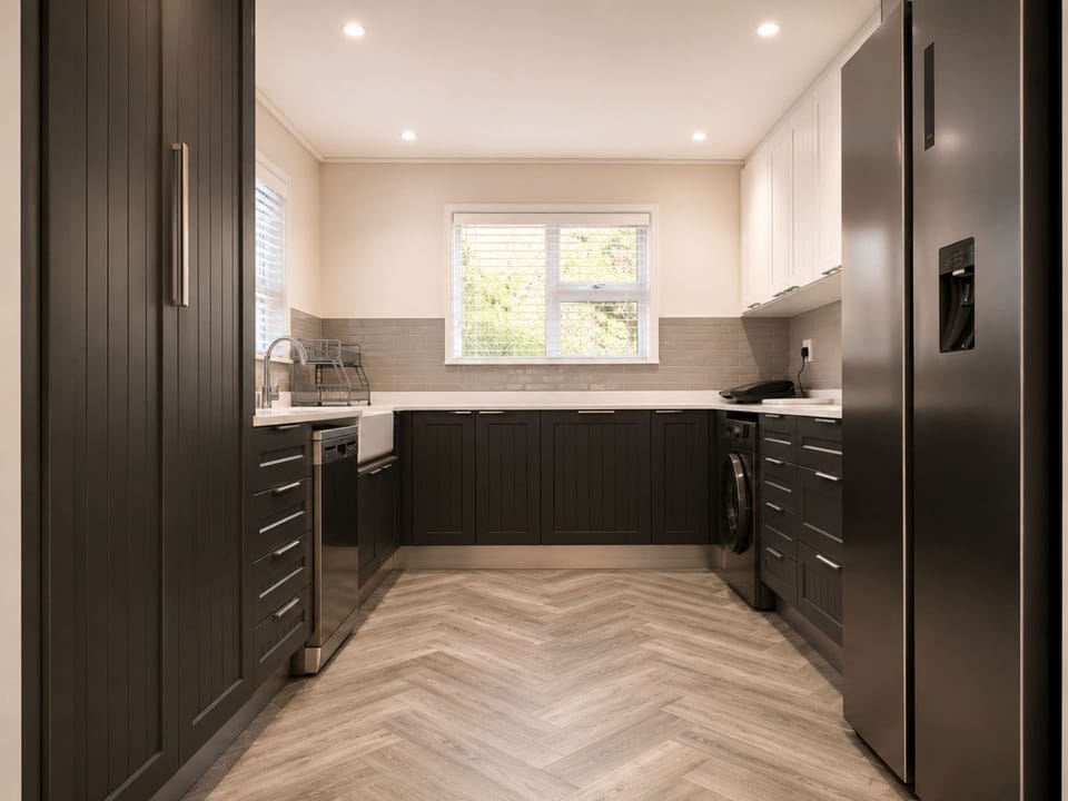 The kitchen with a washing machine and dishwasher