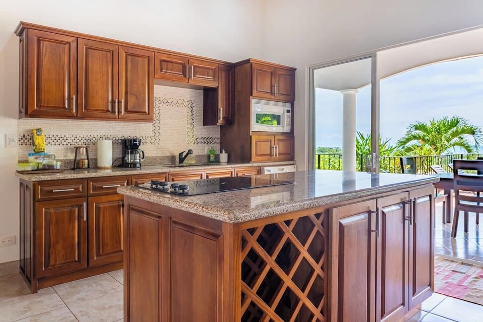 Well-equipped kitchen next to the patio. 