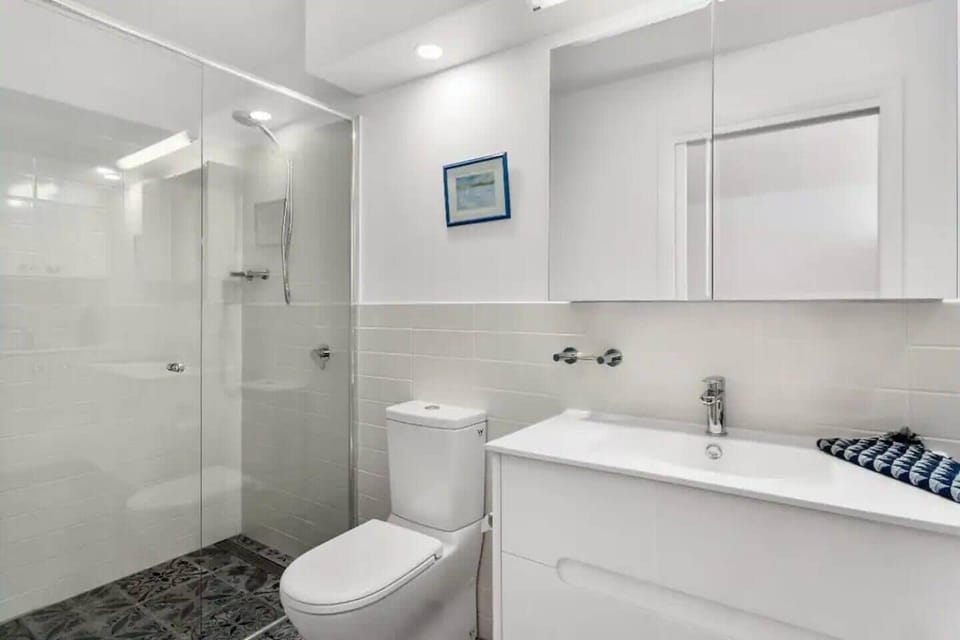 Indulge in the full bathroom, featuring beautiful Spanish tiles, a walk-in shower, and in-floor heating.