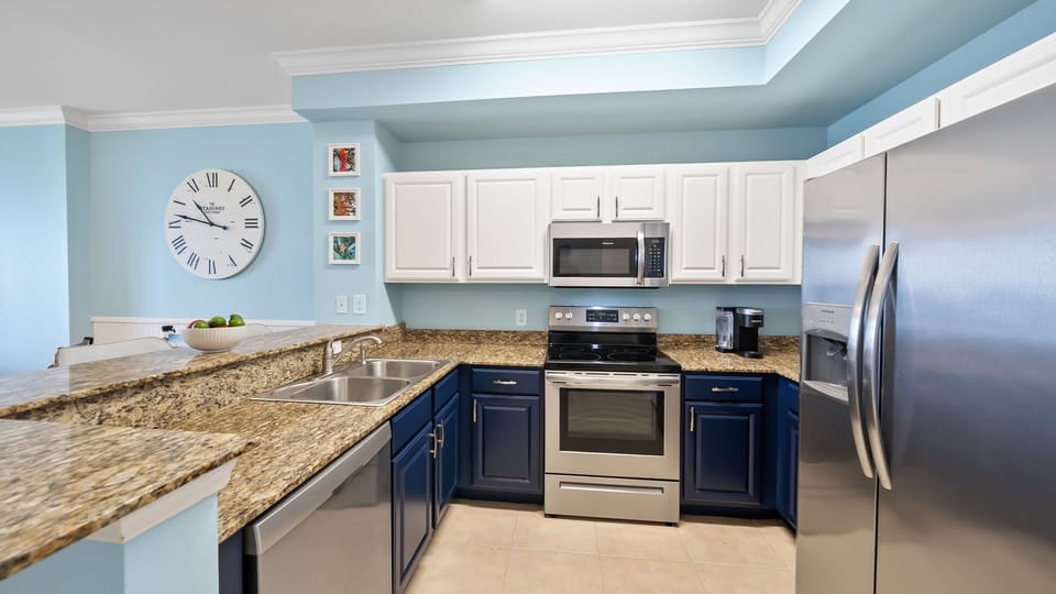 Fully-equipped kitchen with stainless steel appliances, perfect for preparing meals during your beach getaway.
