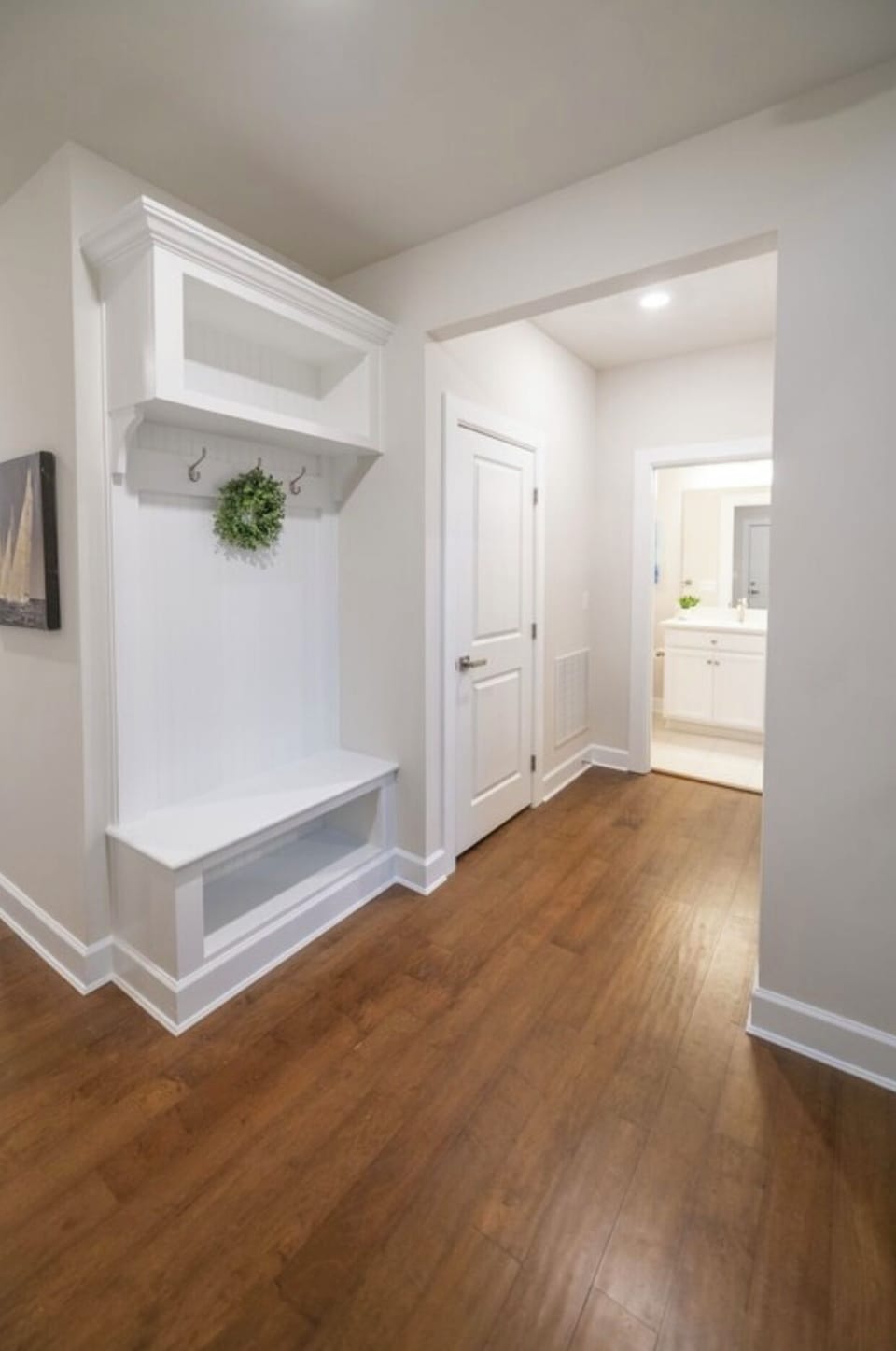 This charming nook with a built-in bench offers the perfect spot to sit and get ready for your day, combining both functionality and coziness.