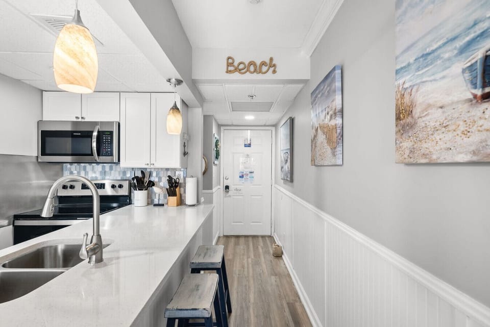Bright, updated kitchen with coastal décor and plenty of counter seating to welcome you in.