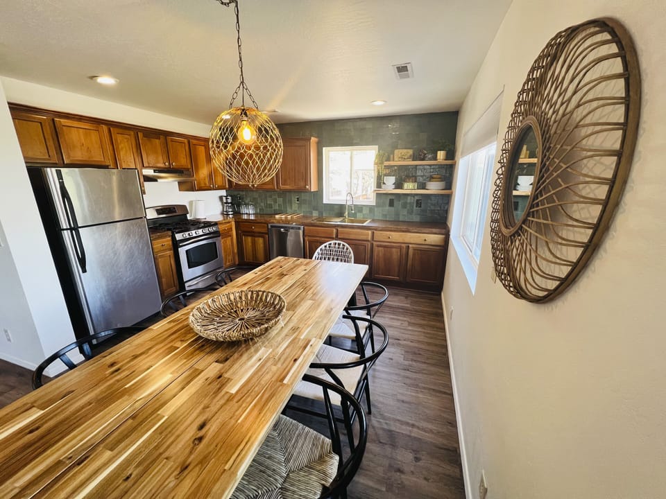 Well equipped kitchen with a large dining room table for 8 or more people to sit