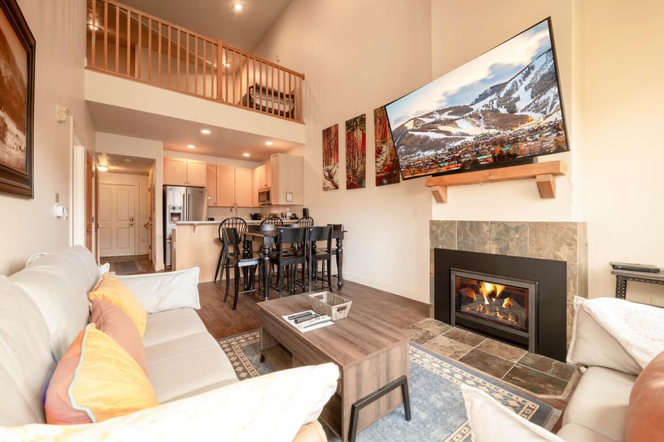 Open concept living, dining and kitchen area with new fireplace & natural light
