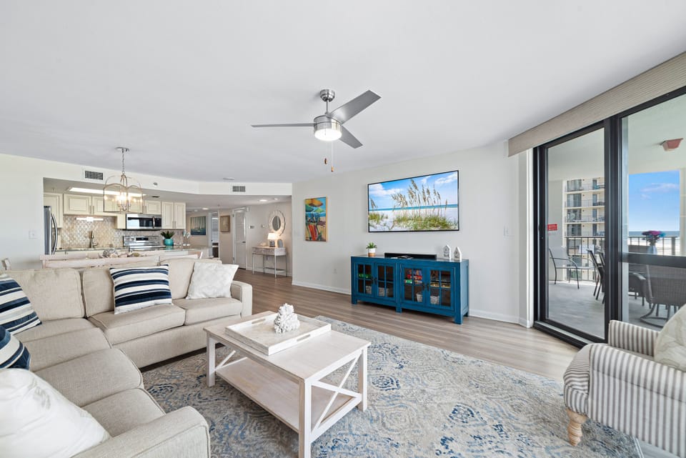 This well-appointed living space offers a comfortable sectional sofa, elegant coffee table, and a dining area with seating for 8, creating a welcoming atmosphere.