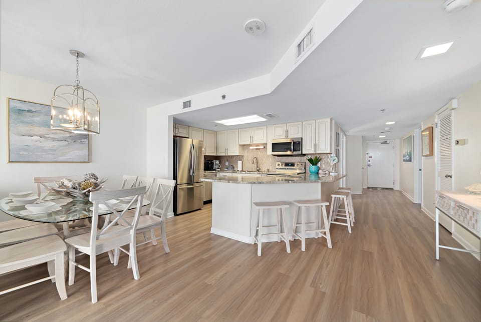 Whip up your favorite meals in this fully-equipped kitchen, featuring stainless steel appliances, ample counter space, and a convenient breakfast bar for casual dining.