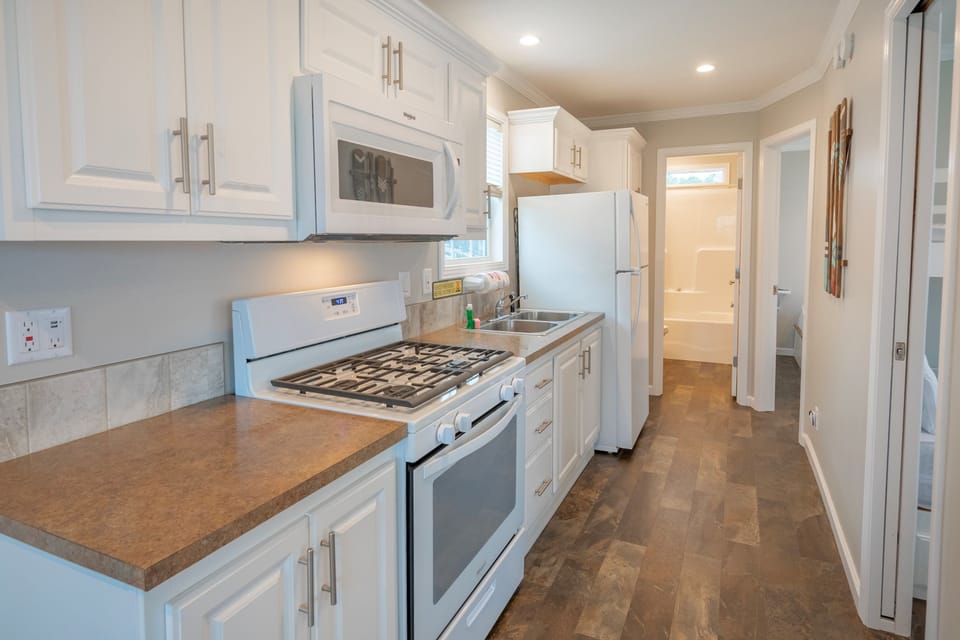 Our convenient kitchen features a stovetop, microwave, toaster, refrigerator, and coffeemaker.