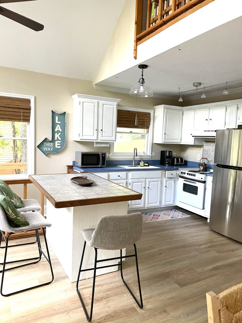Kitchen with fridge, electric stove, toaster, microwave, coffee pot… 