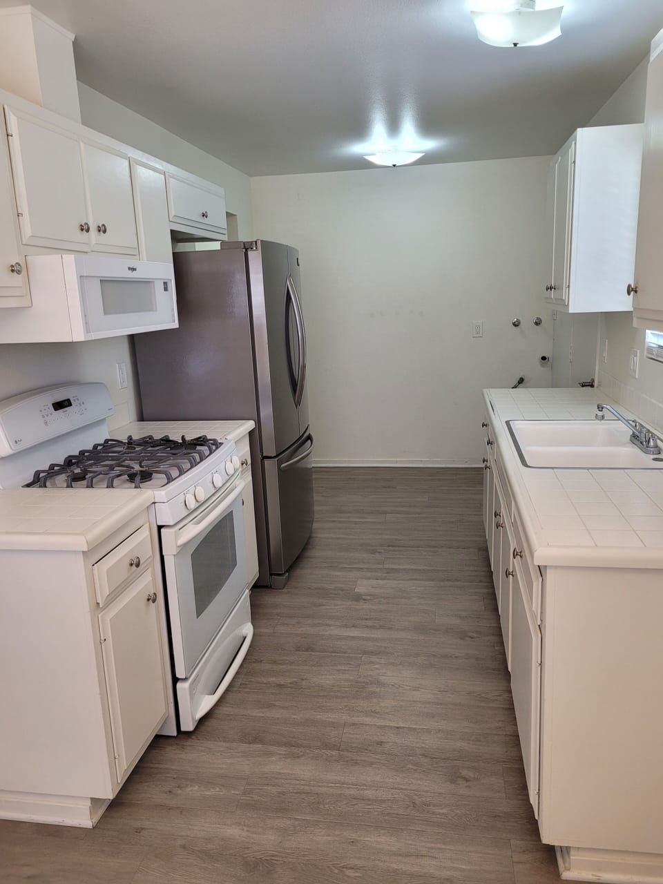 Kitchen has gas stove, refrigerator, micro, coffee maker, toaster oven, etc