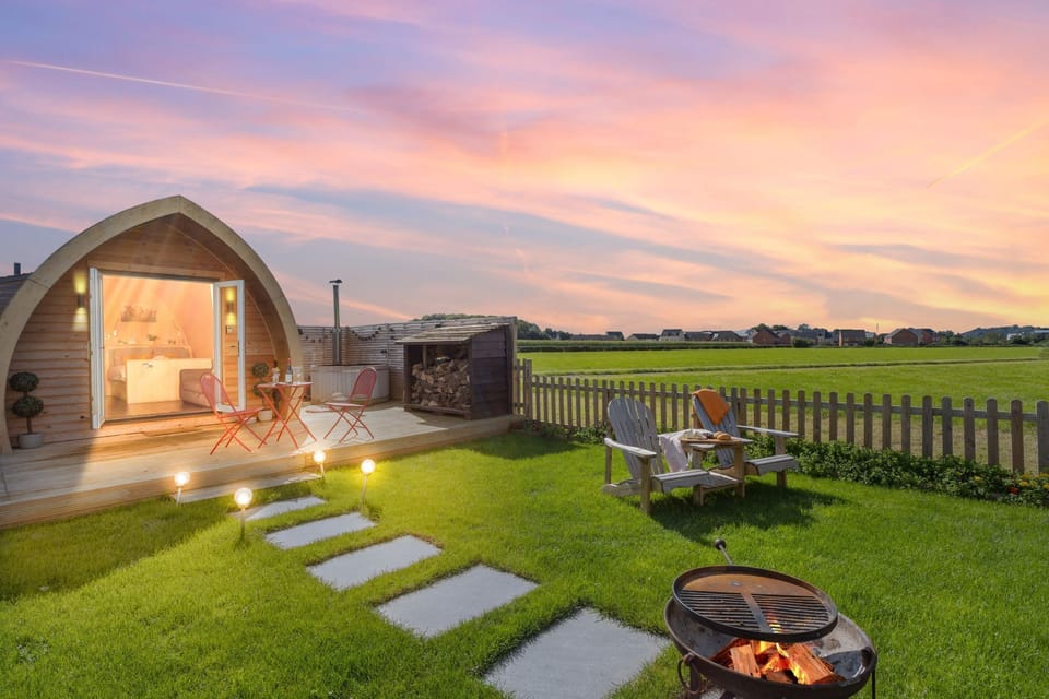 The garden at Chapterhouse with a firepit, seating and a hot tub - Chapterhouse