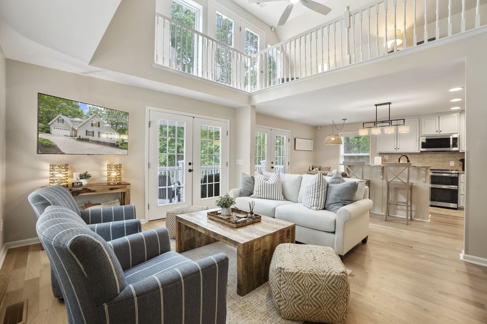 Bright, open living room with deck access & TV.