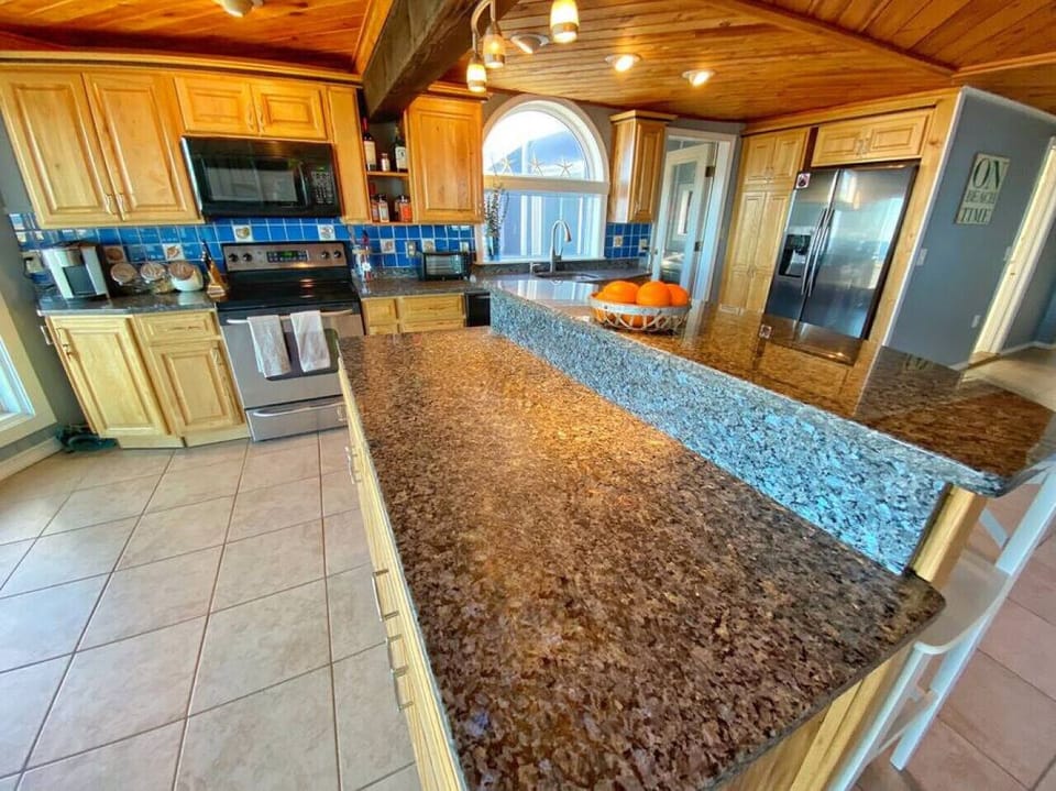 The expansive island provides plenty of seating and workspace while enjoying oceanfront living.