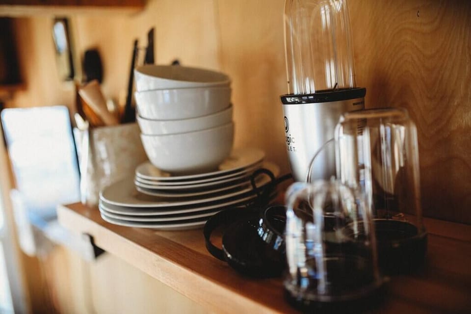 "Fully equipped kitchen with essential glassware, plates, and kitchen tools for your cozy retreat in Alaska.