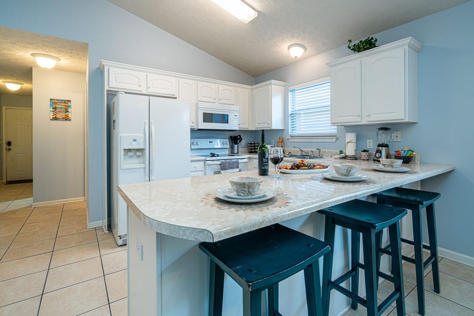 Kitchen: Whip up culinary delights at this stylishly appointed kitchen with a spacious bar!