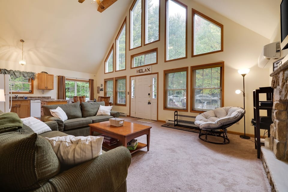Living room with gas fireplace, comfortable couches, TV and coffee table
