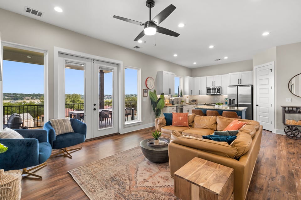 The living room features a gorgeous camel leather sectional.
