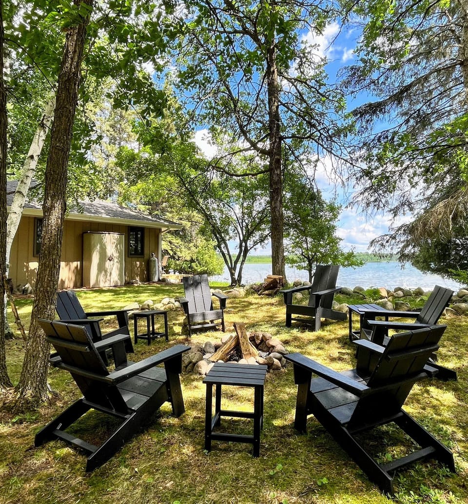 Fire pit with Adirondack chairs and tables
