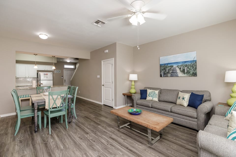 Spacious living, dining and kitchen area with lovely decor and cozy seating