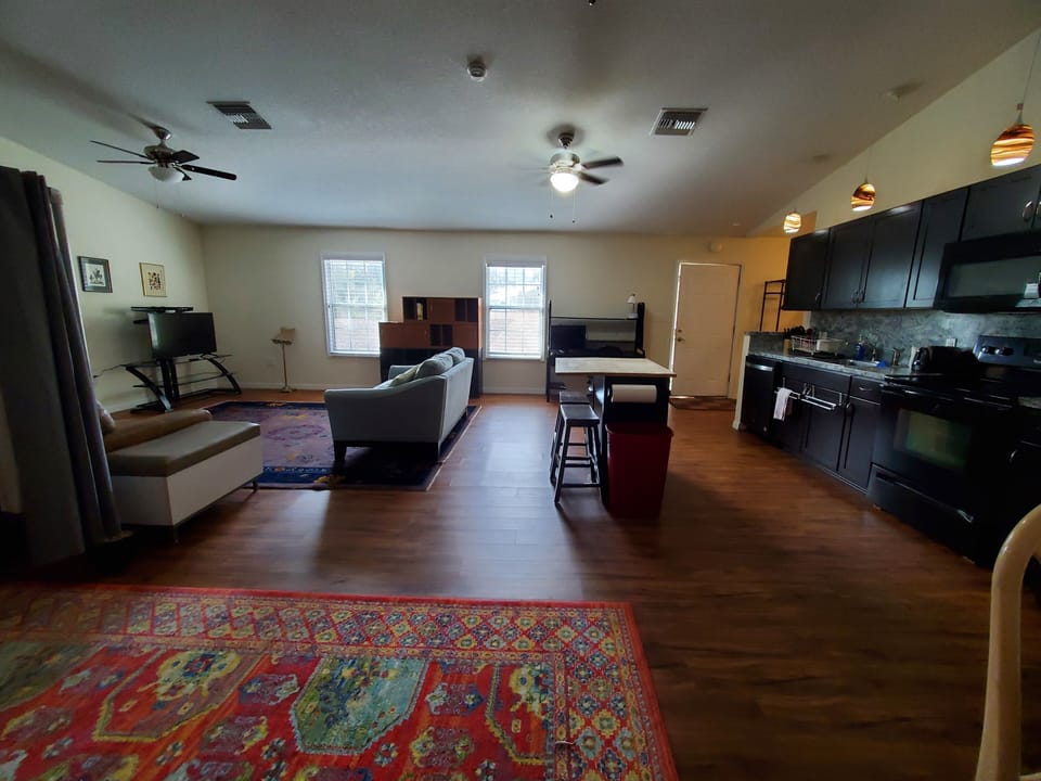 Living room, kitchen area. Bedroom on the left.