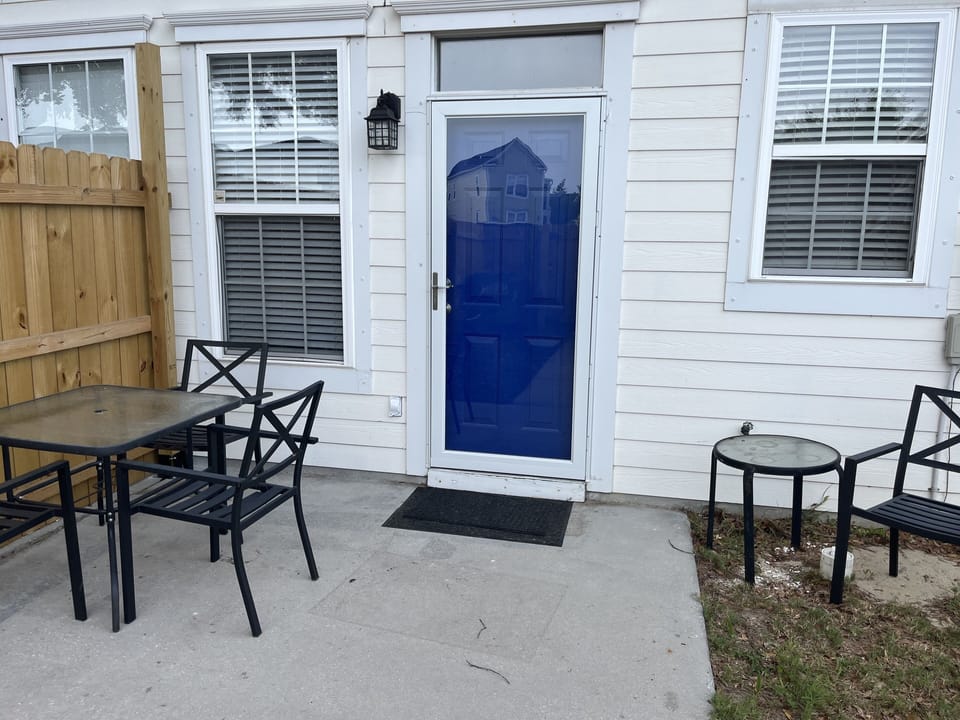 Privacy fenced in backyard with outdoor seating