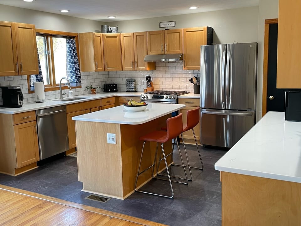 Kitchen w/quartz counters, tile backsplash, gas stove, fully equipped to cook