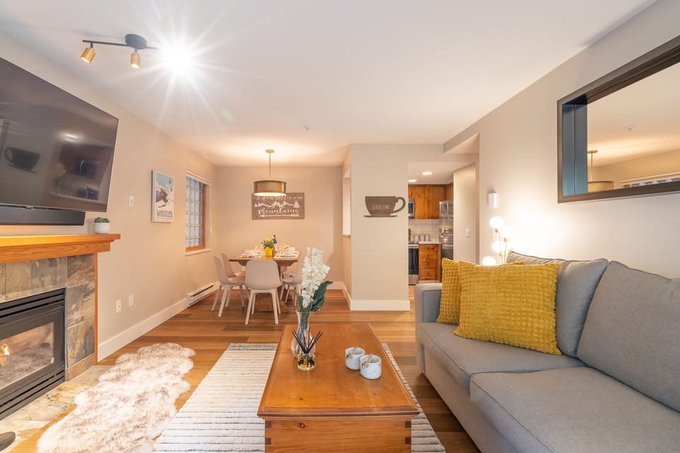Enjoy a 60" HD TV, a cozy fireplace, and an open-plan layout. 