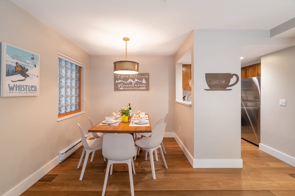 Open plan dining area with wooden floors throughout the townhome.